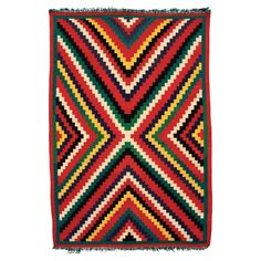 a multicolored rug with fringes on the bottom and one corner in the middle