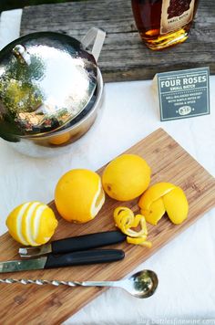 a cutting board topped with sliced lemons next to a tea pot and spoon on top of a table