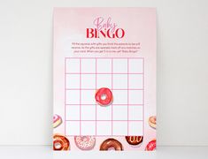 a pink baby shower game with donuts on the grid and words that say baby bingo