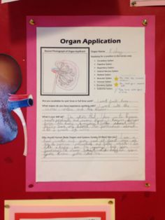 an organ application is displayed on a bulletin board with glasses and other items around it