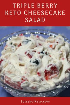 triple berry keto cheesecake salad in a glass bowl on a blue tablecloth