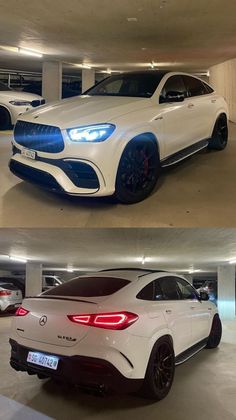 two different cars are parked in a parking garage, one is white and the other is blue