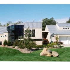 a large house sitting on top of a lush green field