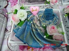 there are many different items on the table and one is blue with pink, white and green flowers