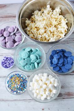 six bowls filled with marshmallows and sprinkles next to each other