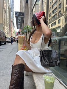 A woman in a flowy white dress sips coffee on a quiet NYC street, showcasing aesthetic daytime outfits. The summer vibes and urban energy contrast with her serene moment, capturing a blend of sophistication and everyday life. This scene is a timeless snapshot of New York's vibrant allure.
#nyc #coffeerun #outfitinspo #summerlook Flowy White Dress, Daytime Outfits, White Flowy Dress, Coffee Run, Nyc Street, Aesthetic Coffee, Deep Black, Gray Dress