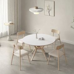 a white table and four chairs in a room