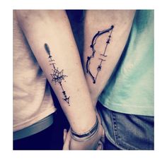 two people holding hands with tattoos on their arms and one has an arrow in the middle