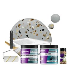 an assortment of paint, tools and supplies for painting on a white background with gold confetti sprinkles