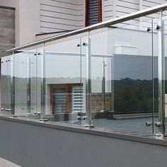 a balcony with glass balconies and railings on the side of a building