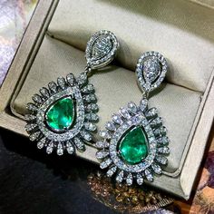 ONE OF A KIND HANDCRAFTED EARRINGS. BOHEMIAN! STUNNING 4.33 TCW, Certified COLOMBIAN Emerald earrings. UNIQUE DESIGN! ONE OF A KIND! TRANSPARENT, SPARKLING EMERALDS IN PAIR! Extremely rare! Surrounded by TOP GRADE, E/VVS DIAMONDS! Set in 18K solid white gold earrings. Our jewelry are specially designed, and are delicately handcrafted by local Thai, professional goldsmiths, who have had decades of experience in creating fine jewelry. SUGGESTED RETAIL VALUE: 18,000 THE ITEM YOU SEE IN THE PICTURES Luxury Hallmarked Pear-shaped Diamond Earrings, Luxury Pear-shaped Gemstone Diamond Earrings, Luxury Pear-shaped Diamond Earrings With Gemstones, Luxury Pear-shaped Earrings For Formal Occasions, Luxury Pear-shaped Earrings For Formal Events, Luxury Pear-shaped Emerald Earrings, Formal Platinum Earrings With Gemstone, Formal Platinum Gemstone Earrings, Luxury Sterling Silver Pear-shaped Earrings