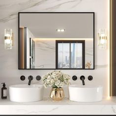 a bathroom with two sinks and a large mirror over it's counter top,