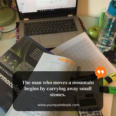 an open book sitting on top of a desk next to a laptop computer and calculator