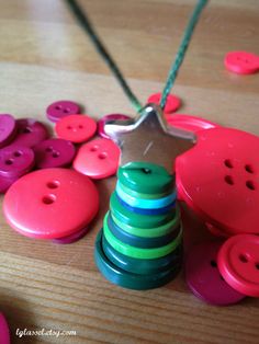 a wooden table topped with lots of colorful buttons and a star shaped ornament