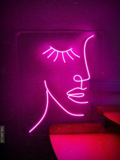 a neon sign with a woman's face on it