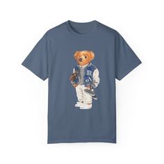 Step into timeless style and unmatched comfort with our Polo Bear Preppy Football Jock Crewneck Tee, crafted on the foundation of the renowned Comfort Colors 1717 garment-dyed t-shirt. Made exclusively with 100% ring-spun US cotton, this tee boasts durability, softness, and a relaxed fit that's perfect for all-day wear. Features: Premium Quality: The Comfort Colors 1717 tee is crafted from medium-weight fabric (6.1 oz/yd²) for a luxurious feel and long-lasting wear. Customizable Colors: Explore our extensive palette of 58 colors in the Comfort Colors 1717 collection, ensuring you find the perfect shade to match your style. Versatile Fit: The relaxed fit of this tee makes it ideal for casual outings or dressing up for semi-formal occasions. The crew neckline adds a touch of classic elegance Luxury Blue Polo Shirt With Relaxed Fit, Luxury Blue Relaxed Fit Polo Shirt, Luxury Classic Polo Shirt For Semi-formal Occasions, Luxury Garment-dyed Long Sleeve Tops, Luxury Semi-formal Polo Shirt, Luxury Blue Formal Polo Shirt, Luxury Blue Short Sleeve Shirt With Relaxed Fit, Luxury Timeless Semi-formal Shirt, Luxury Garment-dyed Short Sleeve T-shirt