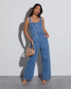 The Simona Sweetheart Denim Jumpsuit is the perfect transitional style for your winter-to-spring wardrobe. It's fitted from the bust through the hips and runs wide through the hem. It's complete with pockets like your favorite pair of jeans. Square neckline Fitted waist, wide leg 5 Classic pockets Front button closures Shell: 100% Cotton, Lining: 100% Polyester Denim Shoes Outfit, Relaxed Fit Denim Button-up Jumpsuit, Medium Wash Button-up Denim Jumpsuit, Blue Relaxed Fit Button-up Denim Jumpsuit, Button-up Denim Jumpsuit With Pockets In Medium Wash, Cotton Denim Jumpsuit With Button Closure, Straight Leg, Jean Jumpsuit, Adventure Style, Denim Shoes