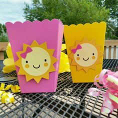 two little sun boxes sitting on top of a table