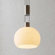 a white light hanging from the ceiling in a room