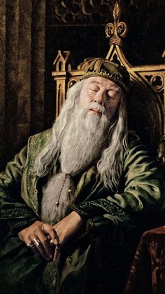 an old man with a long white beard and wearing a green outfit sitting in a chair