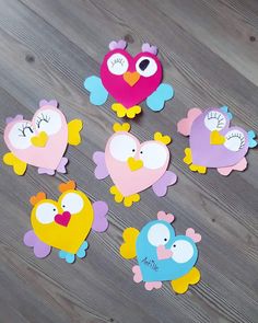 several cut out birds sitting on top of a wooden floor next to eachother