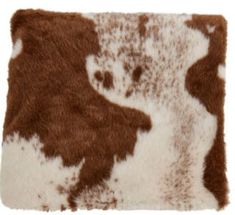 a brown and white cowhide rug on a white background with the animal's fur pattern