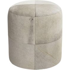 a round ottoman that is made out of sheepskin and has two different sections on the top