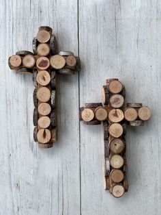 two wooden crosses made out of logs on a white painted wood background with the cross cut in half