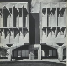 an old black and white photo of two buildings that are made out of concrete blocks