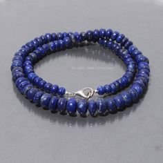 "Product Details :  Item Code : DGC2820 Gemstone Name :  LAPIS LAZULI Chain Style : BEADED Beads Shape : SMOOTH RONDELLE Beads Size :  5mm-9mm Approx Length : 18\" Inch Approx Weight : 200 Cts. Approx Customization : **Available** Please Feel Free To Contact If You Have Any Query." Adjustable Lapis Lazuli Beaded Necklace With 8mm Beads, Lapis Lazuli Round Beaded Necklaces, Lapis Lazuli Single Strand Beads For Gifts, Lapis Lazuli Necklaces With 8mm Beads, Single Strand Lapis Lazuli Beads For Gift, Lapis Lazuli Necklace With 8mm Beads, Necklace With 8mm Round Lapis Lazuli Beads, Lapis Lazuli Gemstone Beads For Jewelry Making, Gift Lapis Lazuli Beaded Necklaces With Round Beads