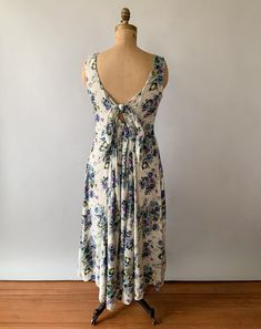 "A gorgeous 90s midi dress that's perfect for spring! Made from cream crinkle rayon with a beautiful blue, purple, green, and brown rose print, the sleeveless dress has a scoop neck with front buttons and flattering princess seaming with a full, gored midi length skirt. It features an open back with back elastic at the skirt and back ties to adjust the fit. Honestly one of the prettiest 90s dresses I've seen! Perfect for layering with sweaters and jackets this spring and then as a sundress all s Vintage 90s Dress, Midi Dress Floral, Tie Back Dress, Dress Open Back, Blue Floral Dress, 80s Dress, 90s Dress, Rayon Dress, Midi Length Skirts