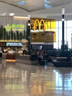 an airport terminal with people waiting for their luggage