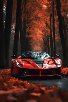 a red sports car parked on the side of a road in front of some trees