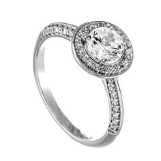 a white gold engagement ring with an oval cut diamond and pave set diamonds around the band