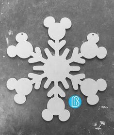 mickey mouse snowflake cut out on a black and white background with the word b below it