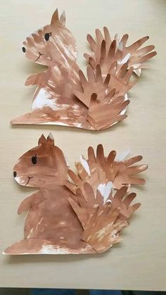 two pieces of paper that have been made to look like hedgehogs on a table