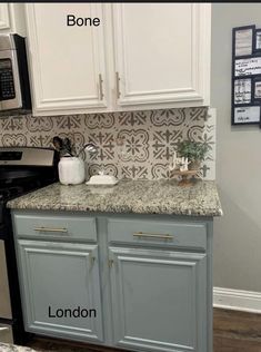 a kitchen with white cabinets and granite counter tops