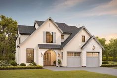 a white house with two garages on the front and one story home in the back