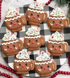 decorated cookies are arranged on a black and white checkered plate