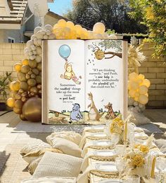 a winnie the pooh birthday party with balloons, books and desserts on it