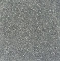 a close up view of the surface of a gray carpet with small speckles