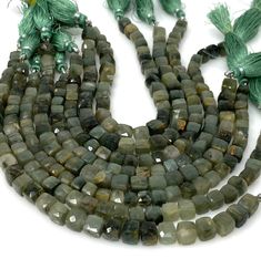 two strands of green glass beads with tassels