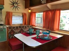 a kitchen area with a table, stove and oven