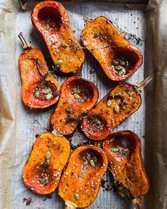 roasted sweet peppers with sesame seeds and seasoning on a baking sheet, ready to be cooked