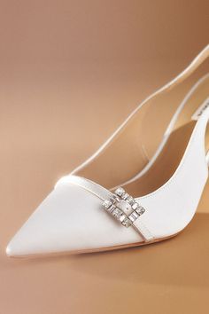 The Badgley Mischka Annmarie Slingback Stiletto Pumps provide a sophisticated lift, while the pointed toe elongates your foot and the adjustable slingback strap ensures a comfortable fit, highlighted by a stunning jeweled vamp buckle for a touch of sparkle. | Annmarie Slingback Stiletto Pumps by Badgley Mischka in White, Women's, Size: 8, Leather/Satin at Anthropologie White Pumps, Stiletto Pumps, 50 Fashion, Badgley Mischka, Evening Wear, Wedding Shop, Heel Height, Anthropologie, Autumn Fashion