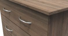 a close up of a wooden dresser with metal pulls on the drawers and wood grained finish