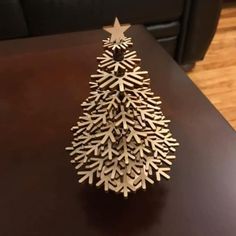 a wooden christmas tree sitting on top of a table