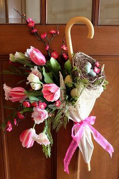 a bouquet of flowers and an umbrella hanging on a door