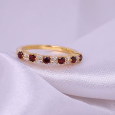 Garnet Diamond Wedding band, Red Garnet stacking bridal ring, 925 Sterling Silver Half Eternity Rings Anniversary Gift Dainty Ring for her Main Stone: Garnet Main Stone Size: 2 MM Main Stone Color: Red Main Stone Shape: Round Birthstone Month: January Secondary stone- CZ Diamond Secondary stone shape - Round Secondary stone color- Colorless Jewelry Type: Half Eternity Band Metal: 925 Sterling Silver Method: Cast Personalization: Possible Occasion: Engagement Style: Art Deco Ring Size: We make ri Garnet Eternity Ring, Garnet Band Ring, Garnet And Diamond Engagement Ring, Garnet Wedding Band, Dainty Promise Ring, Colorful Rings, Bridesmaid Ring, Stackable Birthstone Rings, Garnet Wedding