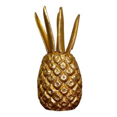 a gold pineapple shaped object with long spikes